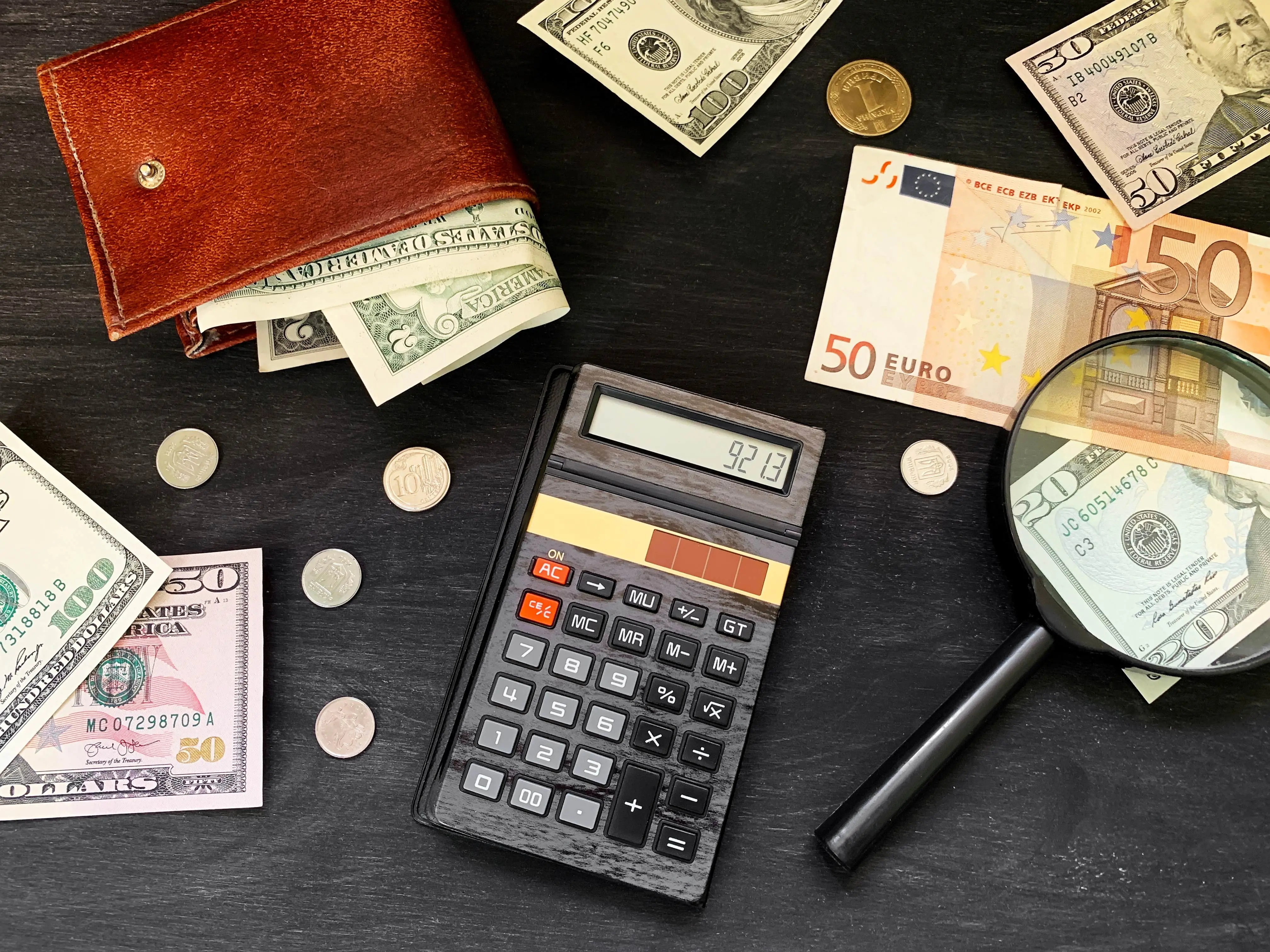 calculator-cash-money-and-wallet-on-black-wooden-2023-11-27-05-04-45-utc