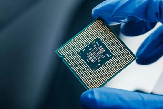 semiconductor-microchip-in-gloved-hand-2023-11-27-05-29-11-utc