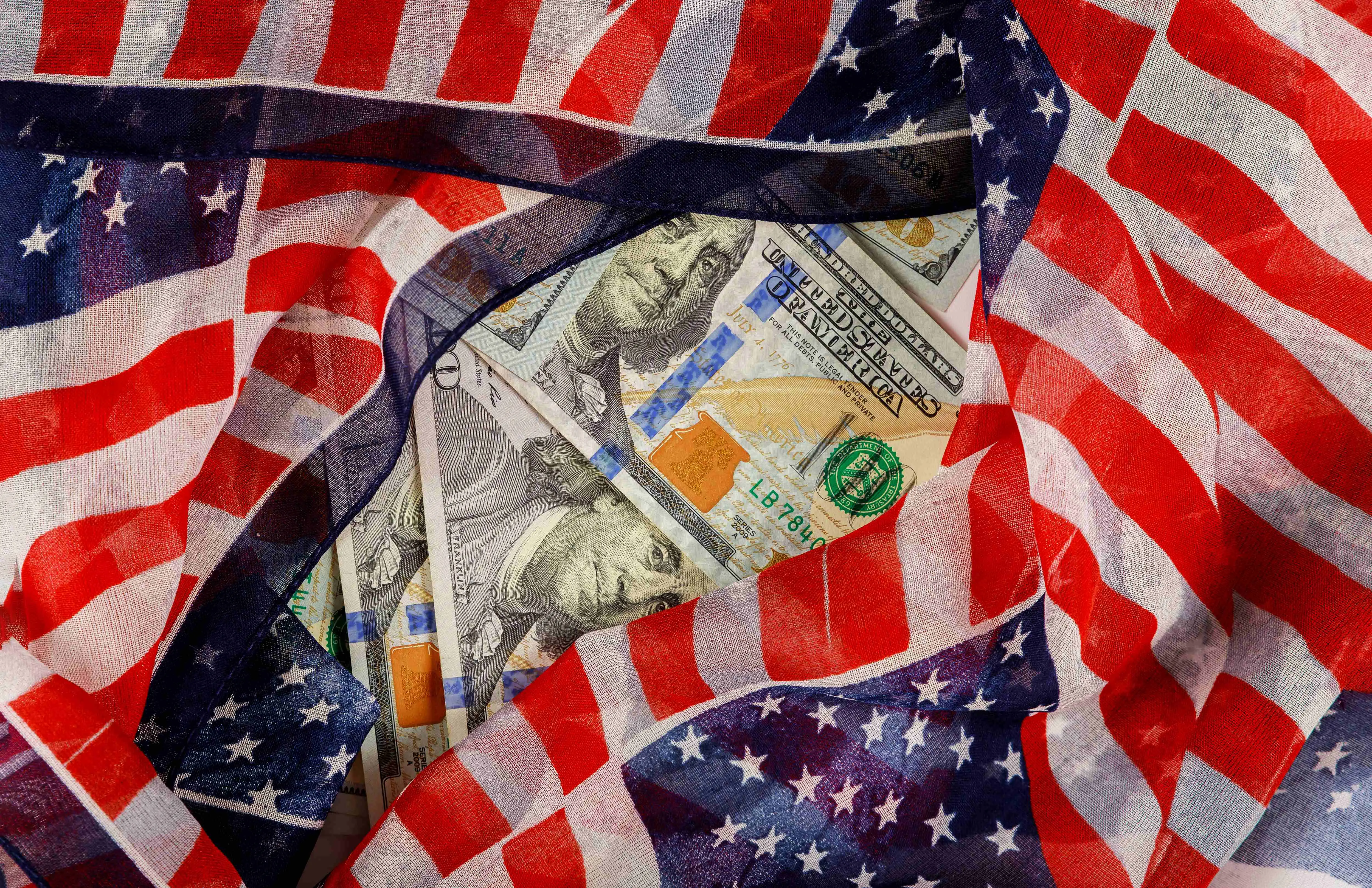 us-100-dollars-wrapped-in-the-us-flag-2025-03-27-03-35-05-utc