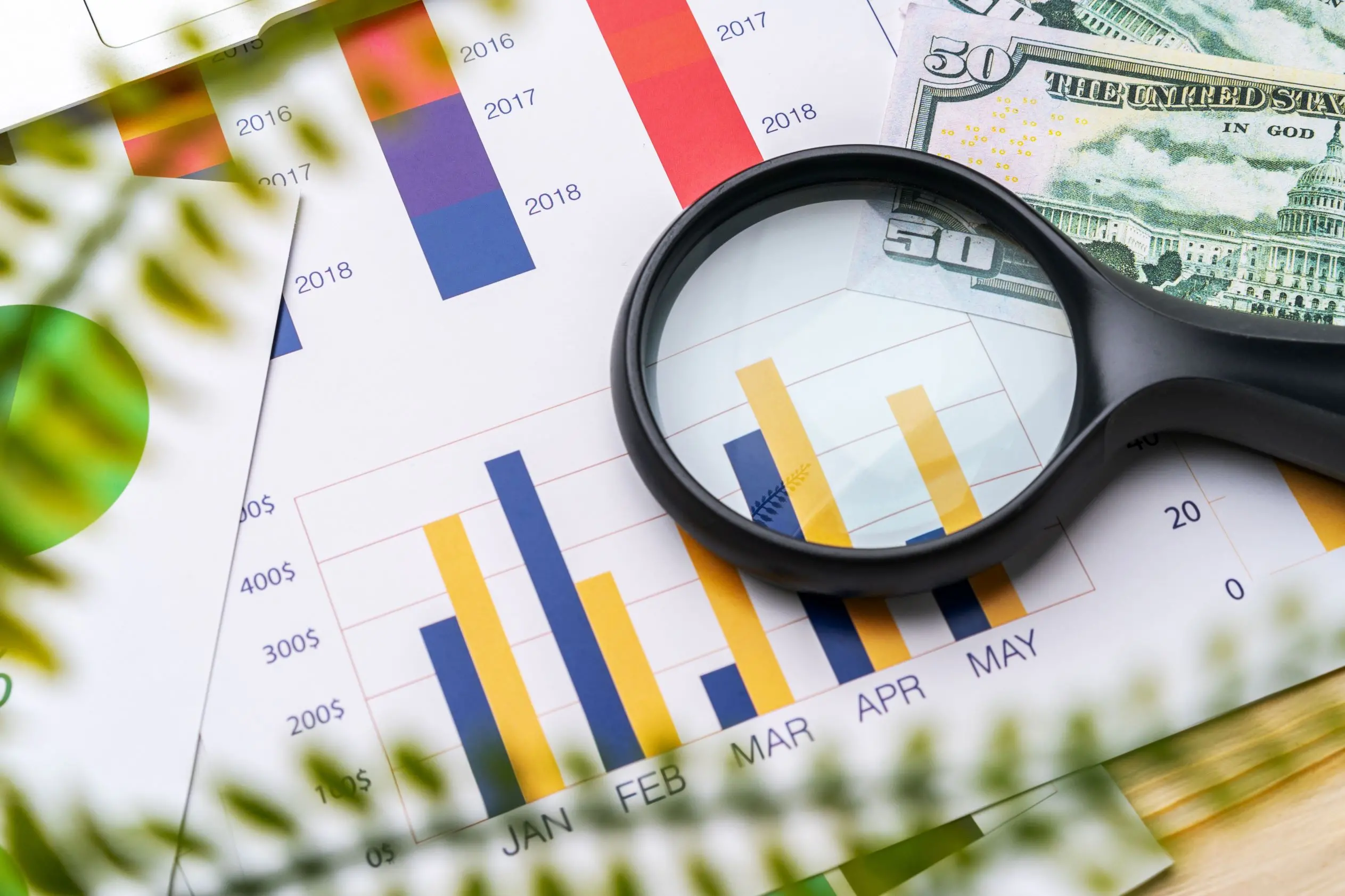 business-graphs-and-magnifying-glass-on-table-2023-11-27-05-09-39-utc